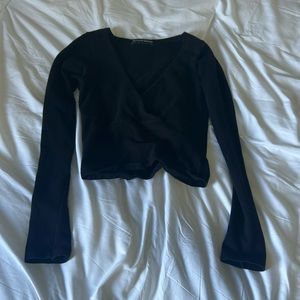 black, slightly cropped cross top from Brandy Melville